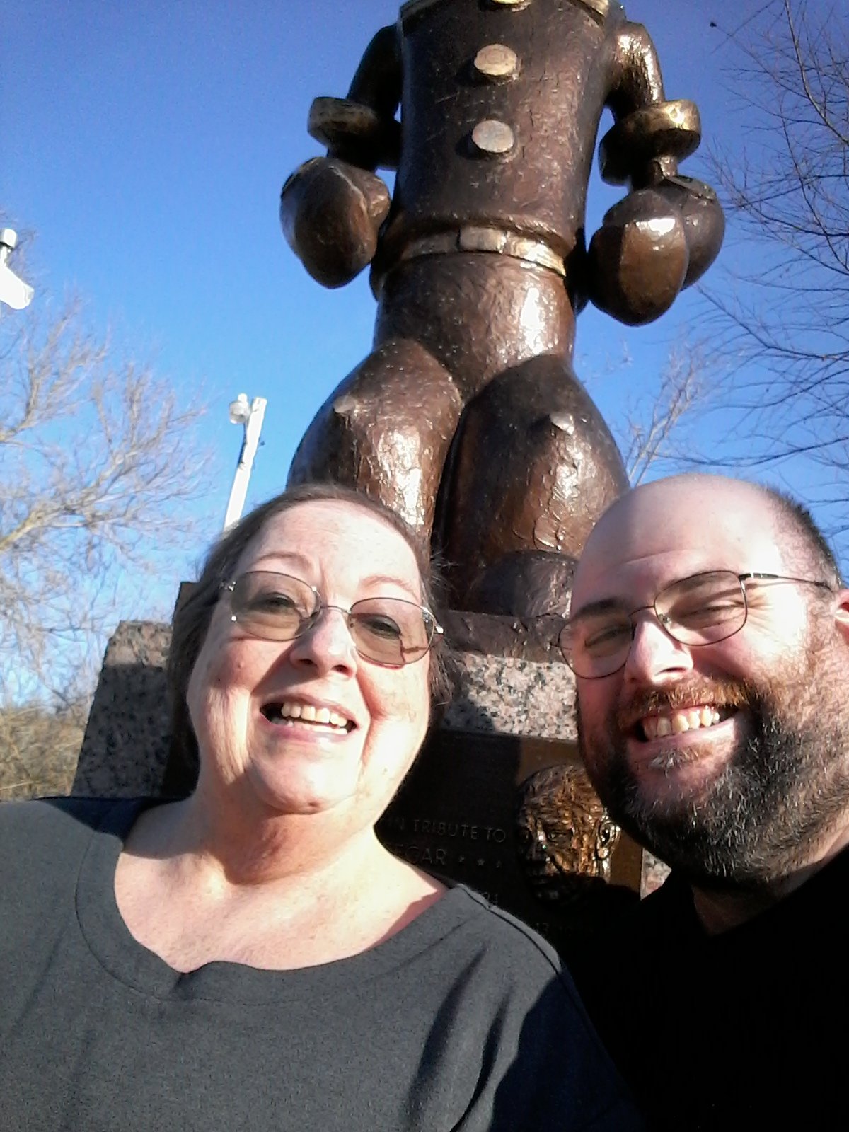 Mother, adult son and cartoon character statue